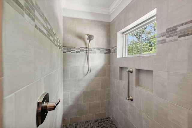 bathroom featuring tiled shower and ornamental molding