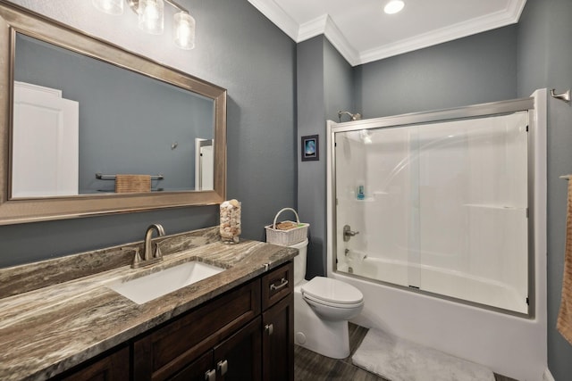 full bathroom featuring vanity, ornamental molding, shower / bath combination with glass door, and toilet