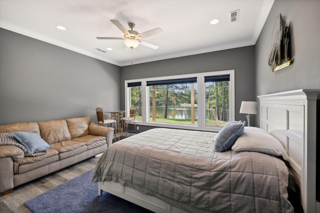 bedroom with light hardwood / wood-style flooring, ornamental molding, and ceiling fan