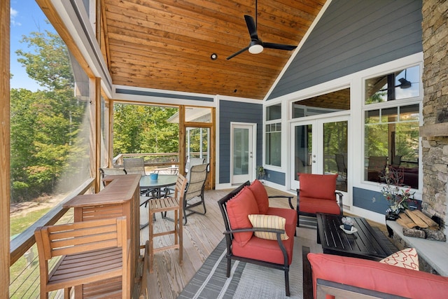 sunroom featuring ceiling fan, lofted ceiling, and wooden ceiling