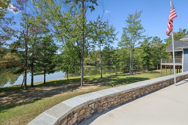 view of property's community featuring a water view and a lawn