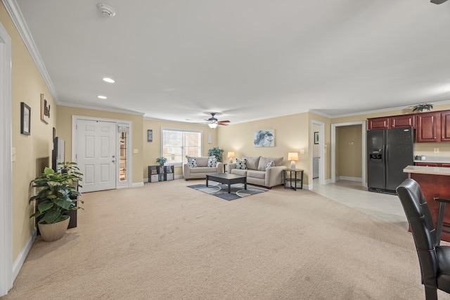 carpeted living room with crown molding and ceiling fan