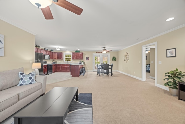 living room featuring ornamental molding, light carpet, and ceiling fan