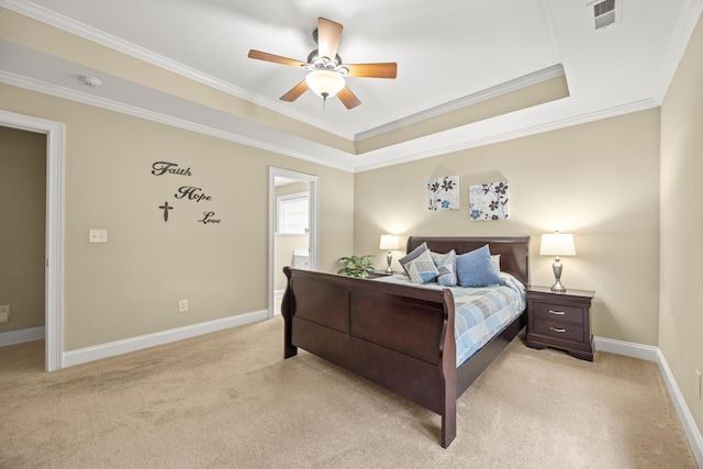 carpeted bedroom featuring crown molding, ceiling fan, and a tray ceiling