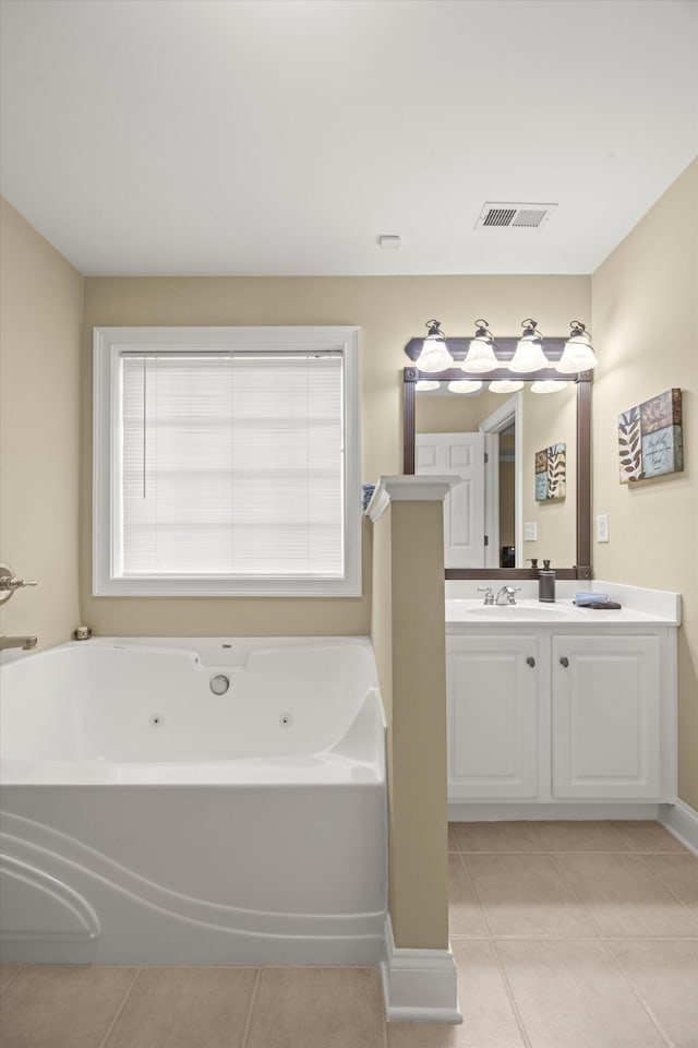 bathroom featuring tile patterned flooring, vanity, and a bathtub