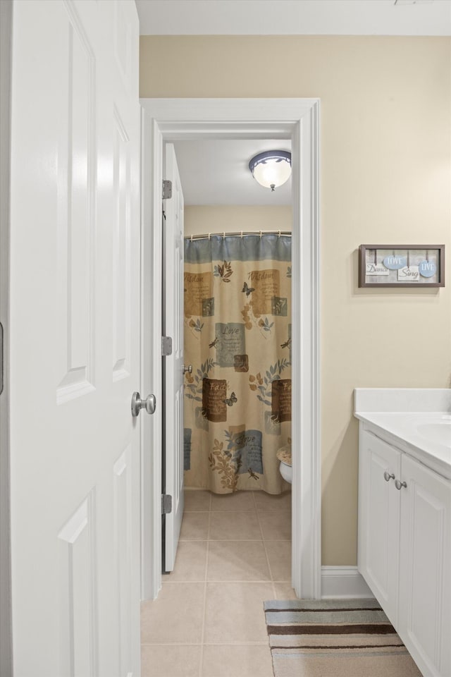 bathroom featuring tile patterned flooring, vanity, and walk in shower