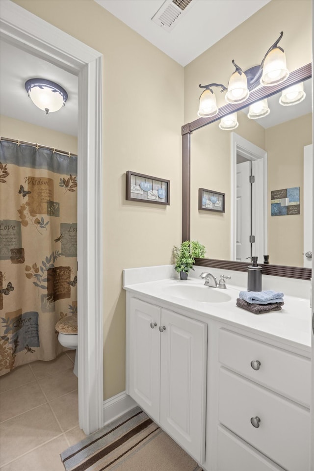 bathroom featuring vanity, tile patterned floors, toilet, and walk in shower