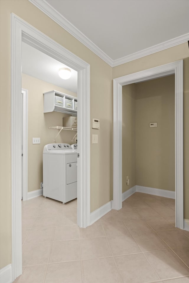 laundry room with light tile patterned floors, crown molding, and independent washer and dryer