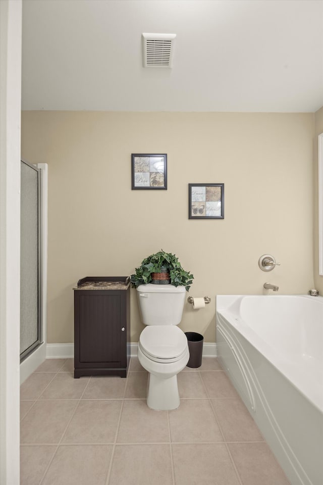 bathroom featuring separate shower and tub, tile patterned floors, and toilet