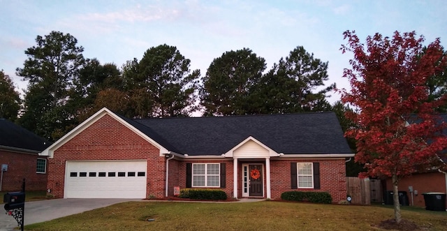 single story home with a garage and a lawn