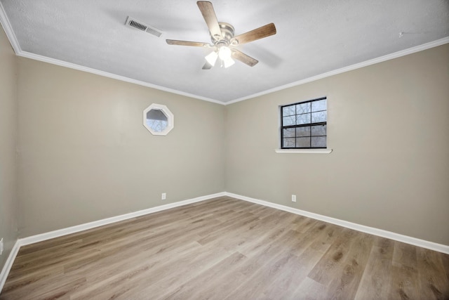 empty room with ceiling fan, crown molding, a textured ceiling, and light hardwood / wood-style floors