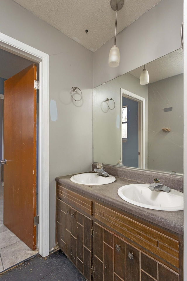 bathroom with vanity and a textured ceiling