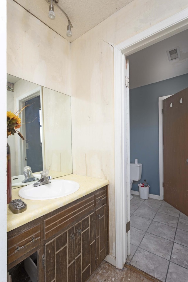 bathroom with tile patterned floors and vanity