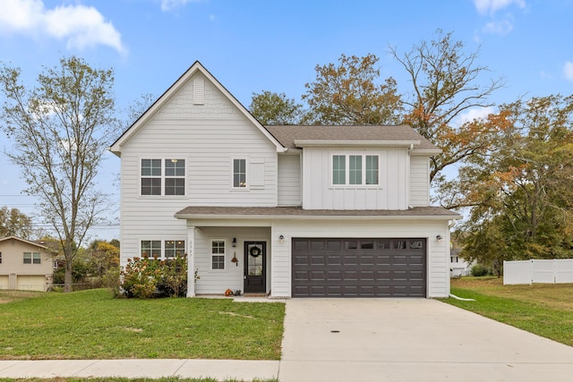 view of front of house featuring a garage and a front lawn