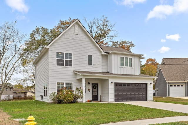 view of front of property with a garage and a front lawn