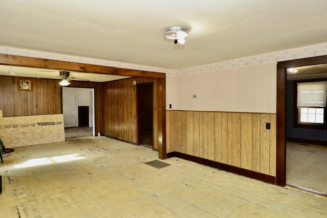 unfurnished room featuring light hardwood / wood-style flooring and wood walls