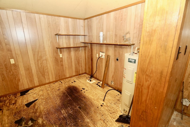 clothes washing area featuring hookup for a washing machine, electric water heater, hookup for an electric dryer, and wooden walls