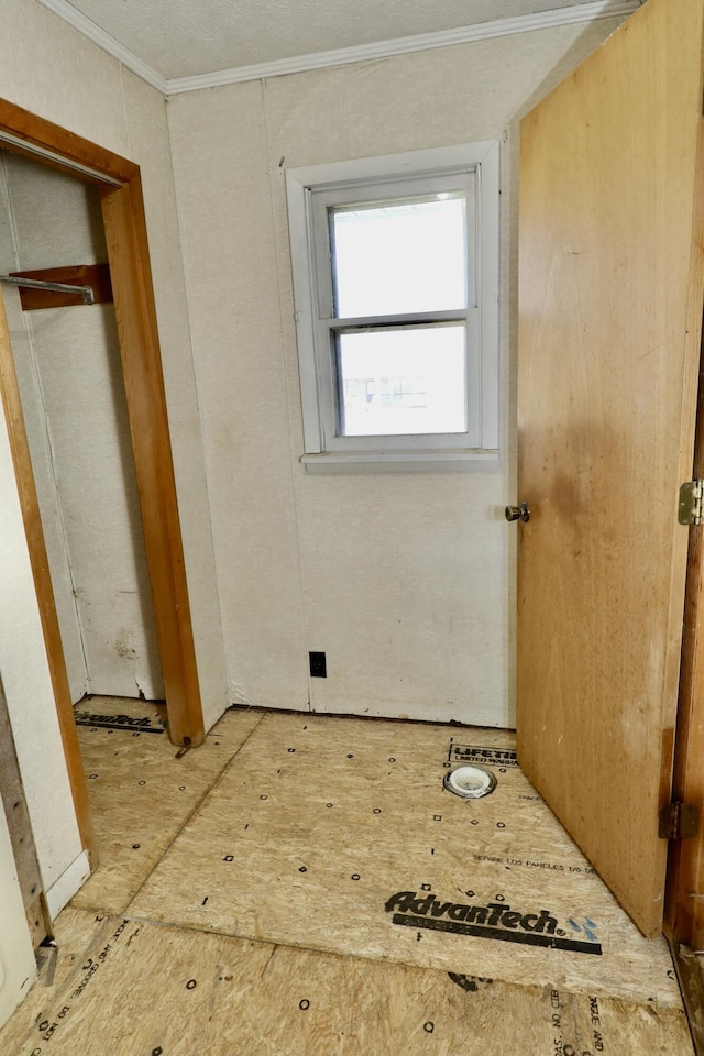 unfurnished bedroom featuring ornamental molding and a closet