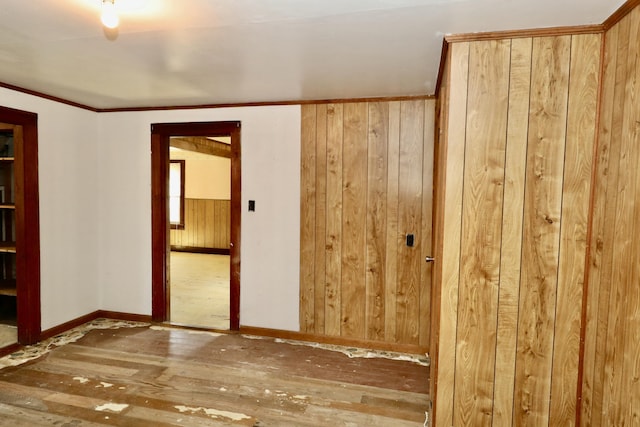 spare room with dark wood-type flooring and wood walls