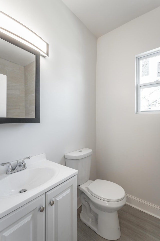 bathroom featuring vanity, hardwood / wood-style floors, and toilet