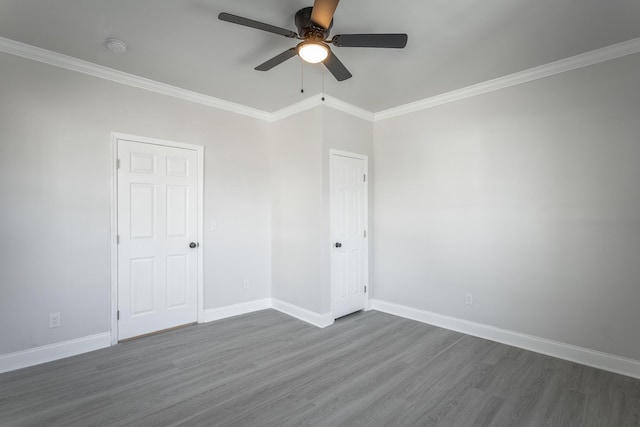 spare room featuring ceiling fan, ornamental molding, and dark hardwood / wood-style floors