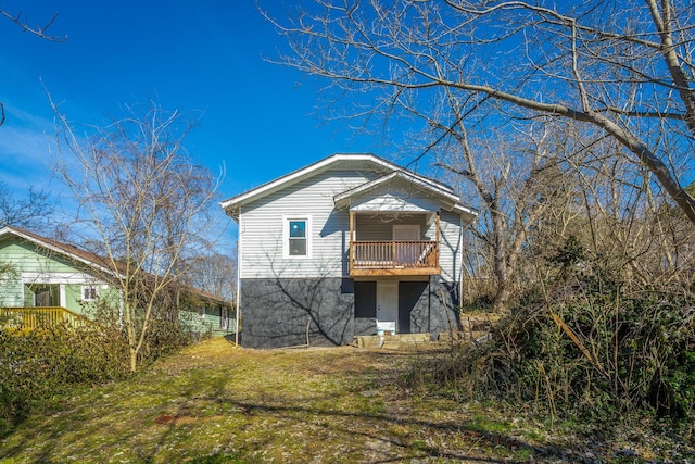 rear view of property with a lawn