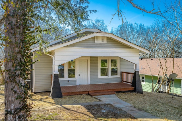 bungalow-style home with a wooden deck