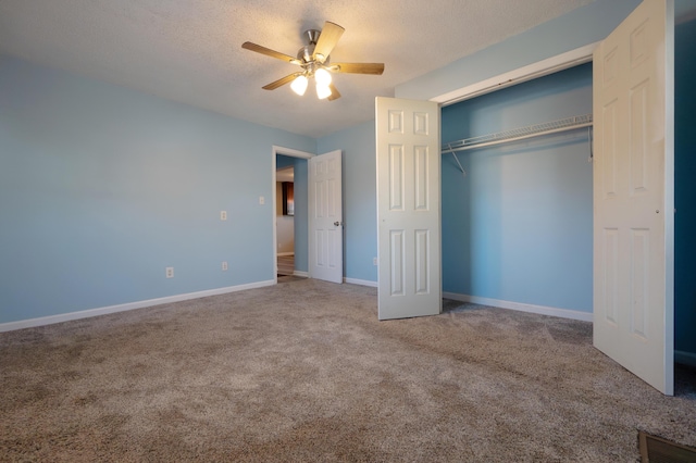 unfurnished bedroom featuring ceiling fan, carpet floors, a closet, and a textured ceiling