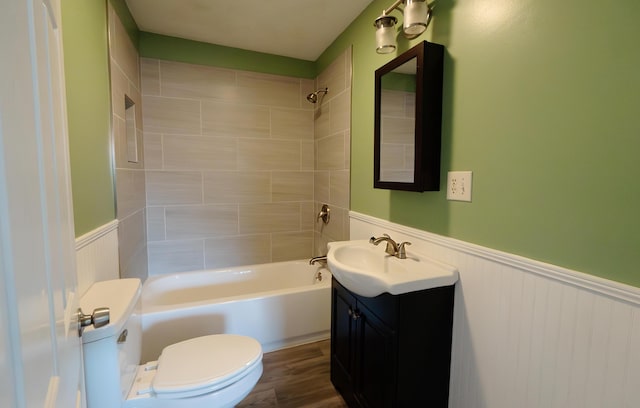 full bathroom with tiled shower / bath combo, vanity, wood-type flooring, and toilet