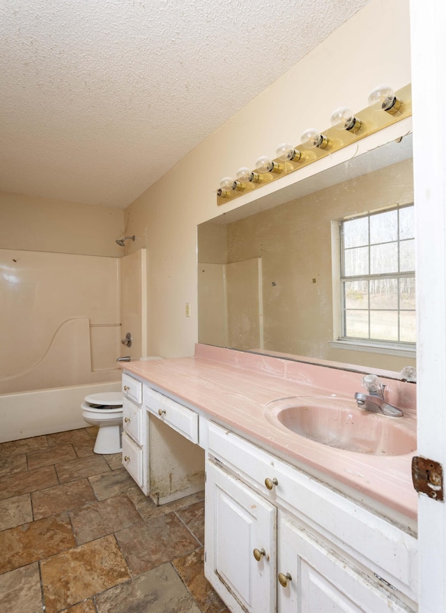 full bathroom featuring vanity, toilet, shower / bath combination, and a textured ceiling