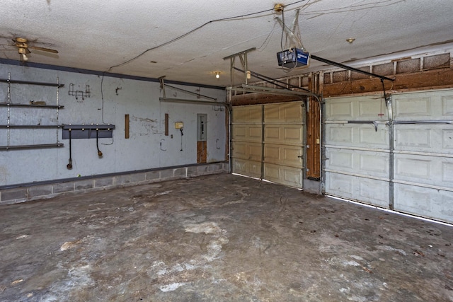 garage featuring a garage door opener and electric panel