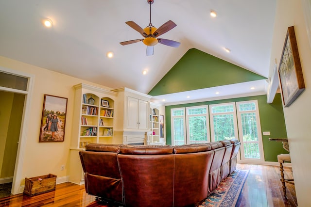 living room with ceiling fan, high vaulted ceiling, and light wood-type flooring