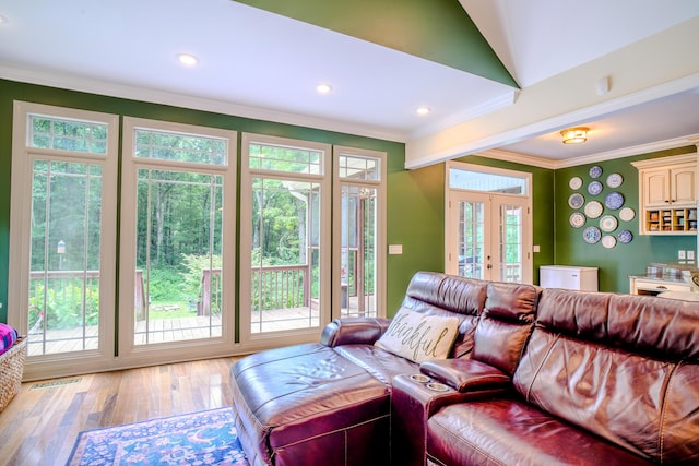 living room with hardwood / wood-style flooring, ornamental molding, and french doors