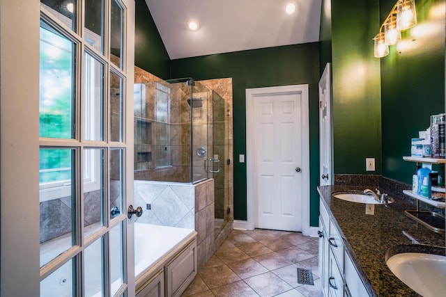 bathroom with vanity, tile patterned flooring, lofted ceiling, and independent shower and bath