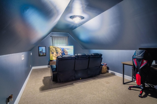 cinema room with vaulted ceiling and carpet floors