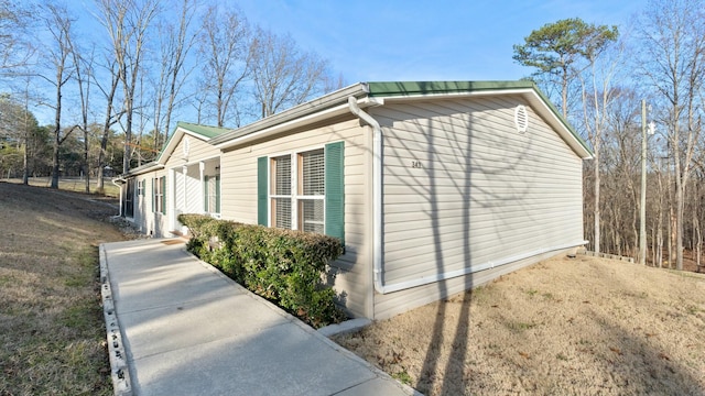 view of side of home with a yard