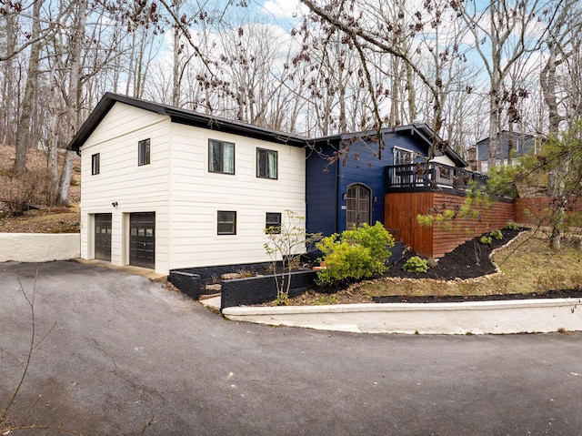 view of front of property featuring a garage and a balcony