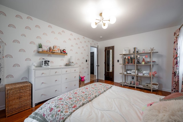 bedroom featuring dark hardwood / wood-style floors and a chandelier