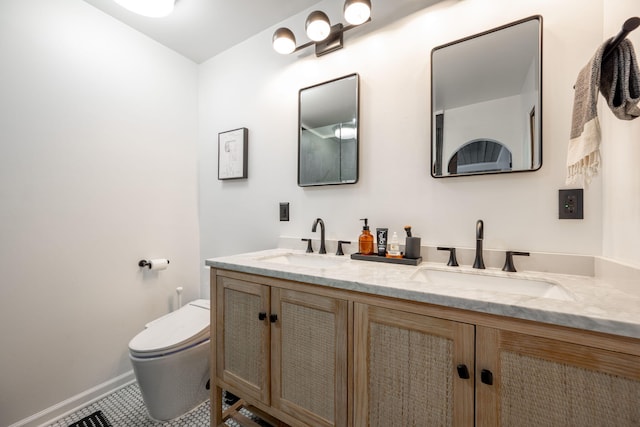 bathroom featuring vanity, tile patterned flooring, and toilet