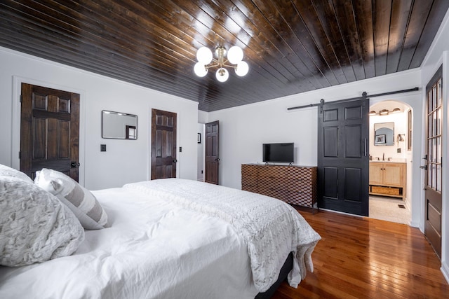 bedroom featuring wood-type flooring, ornamental molding, a notable chandelier, wood ceiling, and a barn door