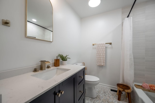 bathroom featuring vanity, curtained shower, and toilet