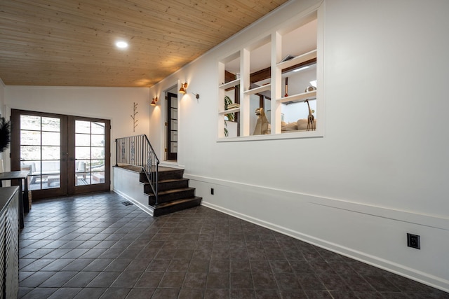 corridor featuring vaulted ceiling, wooden ceiling, french doors, and dark tile patterned floors