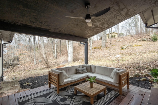 wooden terrace featuring an outdoor living space and ceiling fan