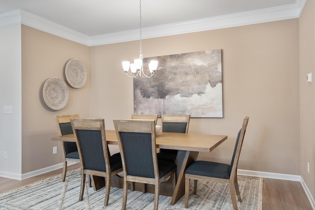 dining room with wood-type flooring, crown molding, and a chandelier