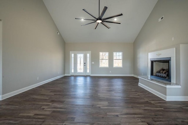 unfurnished living room featuring dark hardwood / wood-style flooring and high vaulted ceiling