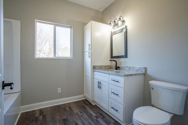 bathroom with vanity, wood-type flooring, and toilet