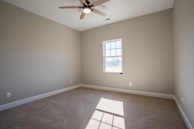 spare room featuring carpet flooring and ceiling fan