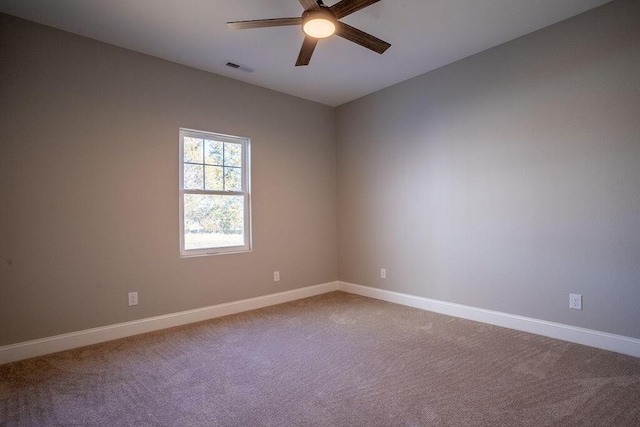 carpeted spare room with ceiling fan