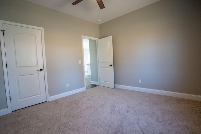 unfurnished bedroom featuring ceiling fan and carpet