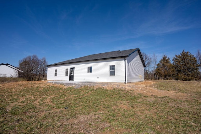 rear view of house featuring a patio area and a lawn